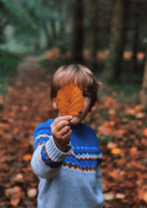 image of child with leaf at fall festival in south jersey
