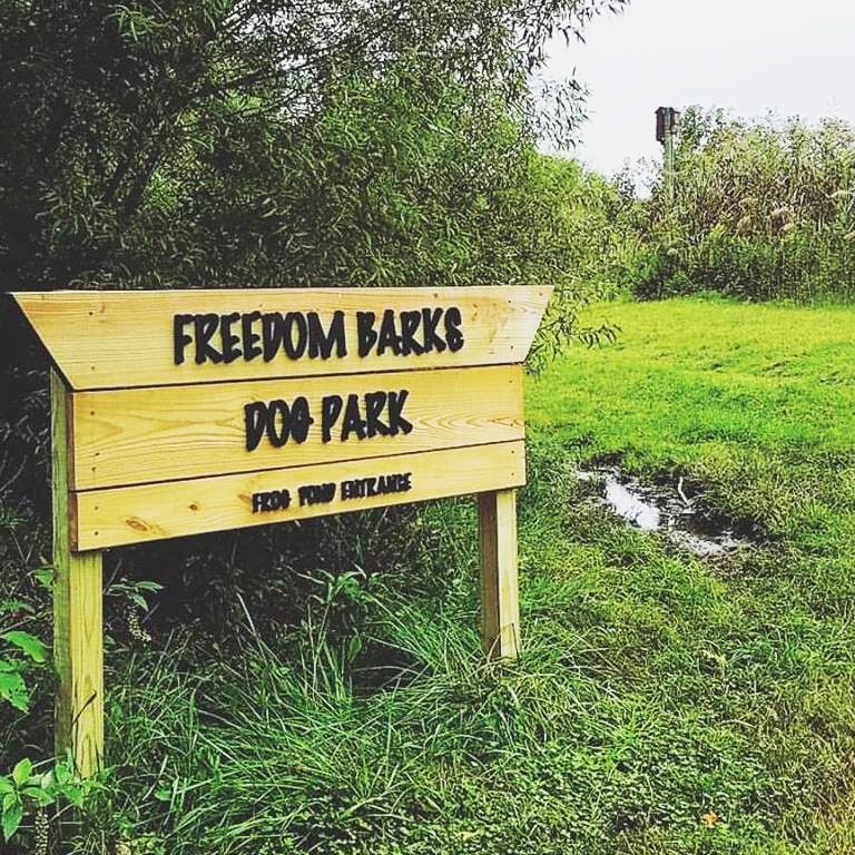 image of Freedom Barks dog park sign