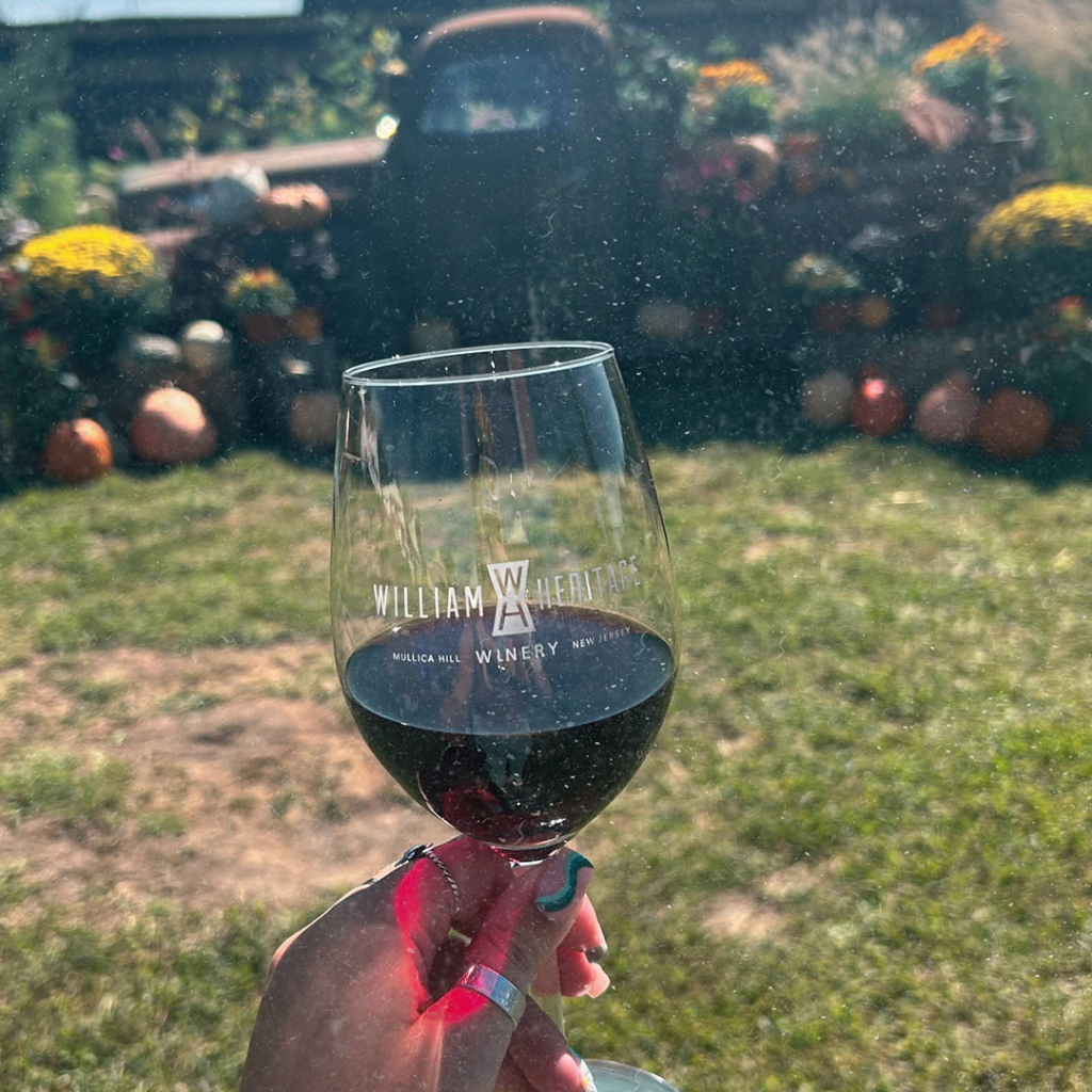 Glass of red wine outside William Hertiage Winery
